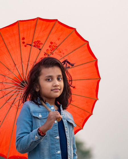 Portrait of girl with red umbrella