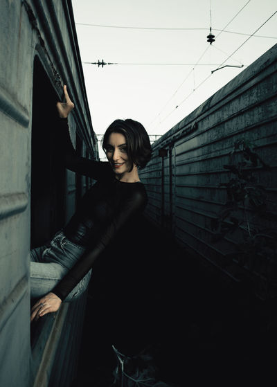 Portrait of woman sitting on train window