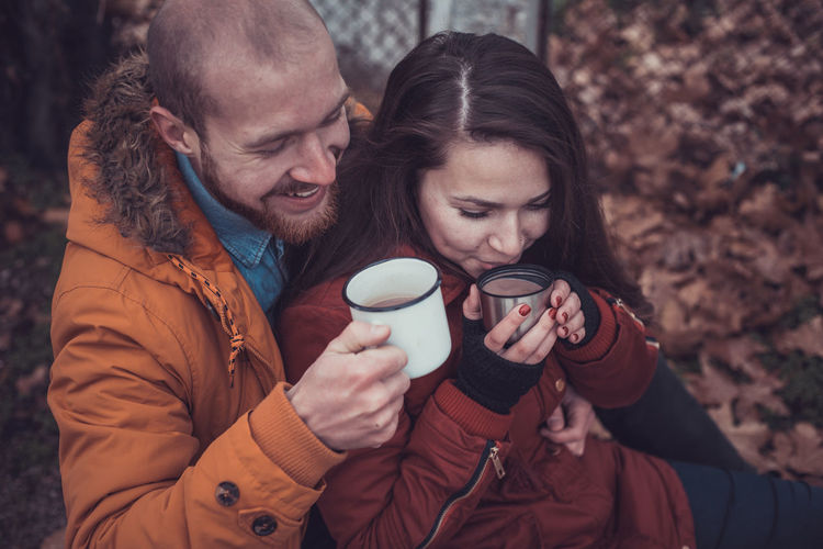 High angle view of couple drinking coffee outdoors