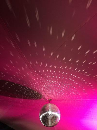 Low angle view of disco ball in nightclub