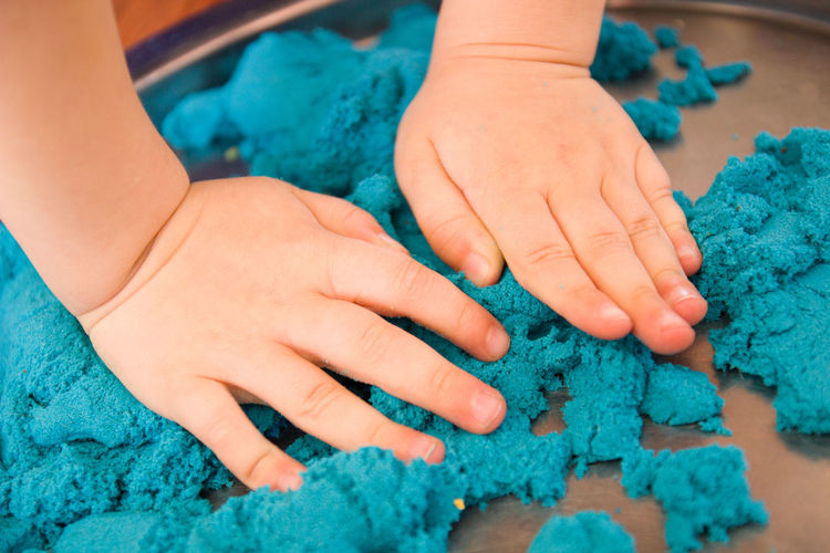 Cropped hands of child with clay