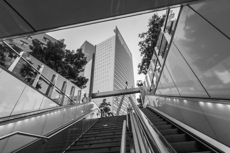 Low angle view of steps and escalators against building