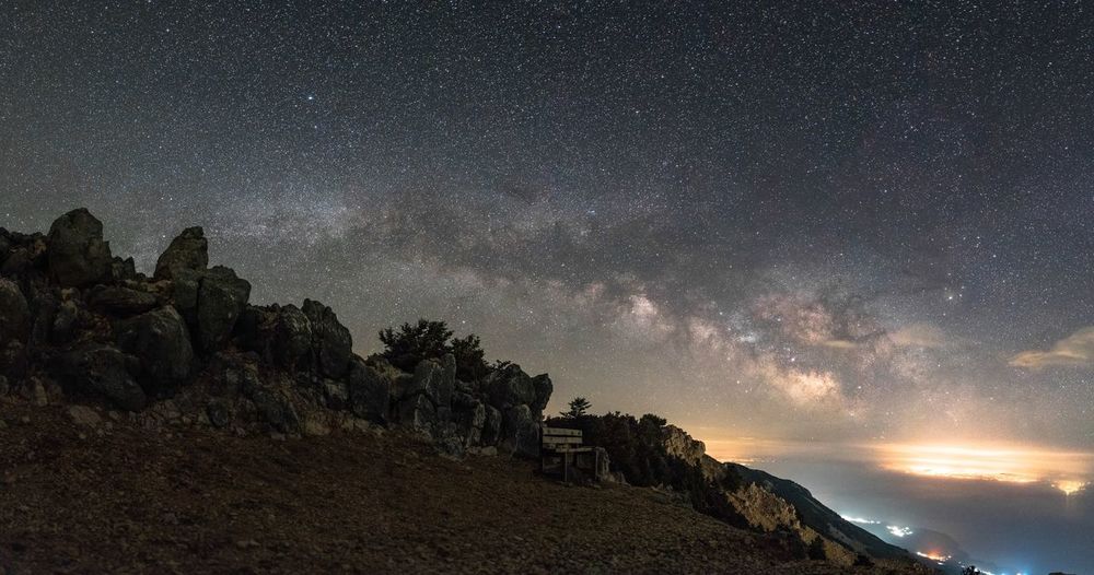 Scenic view of rock formation against sky at night