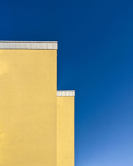 Low angle view of building against blue sky