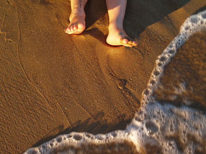 Low section of child on sand