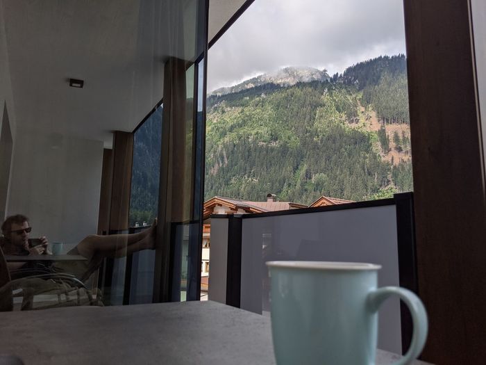 Coffee cup on table by window