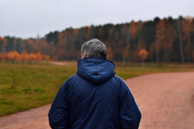 Rear view of man against forest landscape
