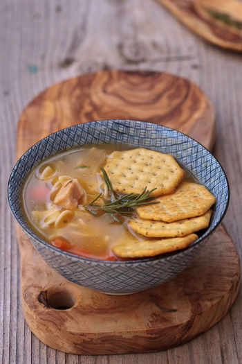 High angle view of soup with crackers on wooden table