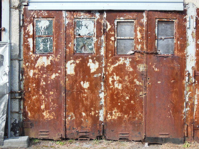 Old rusty metal door of building