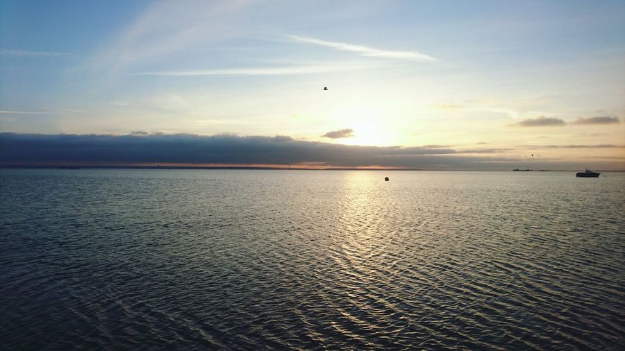 Scenic view of sea against sky at sunset