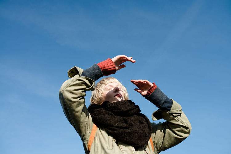 Blue Boys Cap Childhood Clear Sky Day Happiness Leisure Activity Lifestyles Low Angle View Nature One Person Outdoors Real People Sky Smiling Warm Clothing Young Adult Young Women Be. Ready. Be. Ready. The Portraitist - 2018 EyeEm Awards