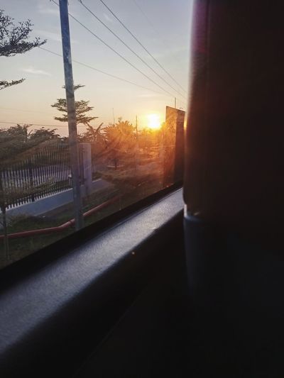 View of sunset through car window