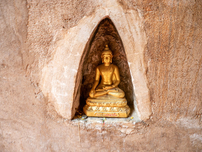 Statue of buddha on wall