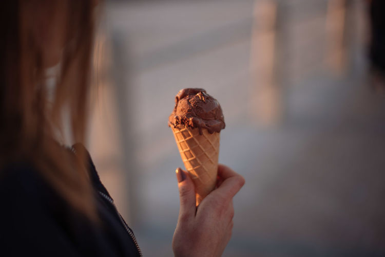 Cropped image of woman holding chocolate ice cream