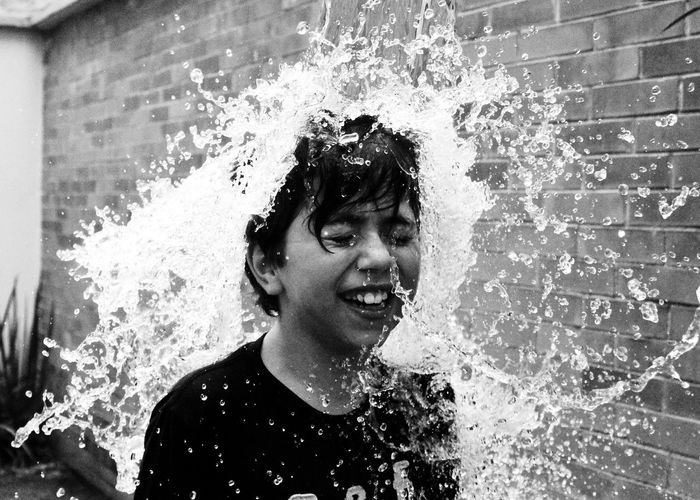 Boy being splashed with water