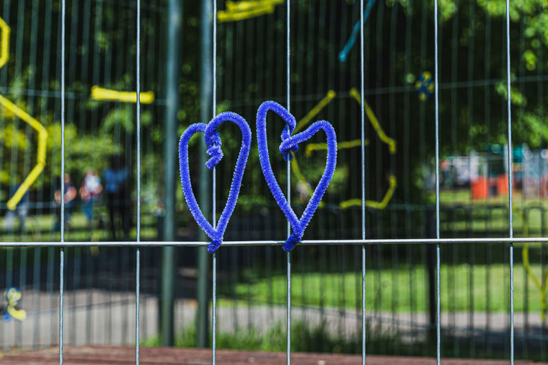 Close-up of heart shape on metal grate outdoors