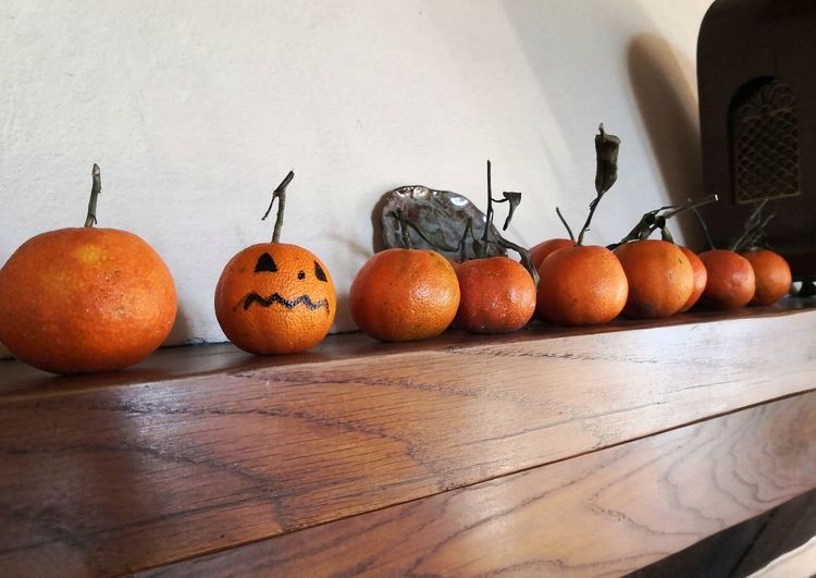 High angle view of pumpkins on table against wall