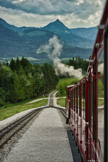 Train on railroad track against mountain
