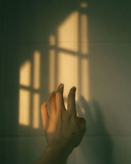 Close-up of hand on wall