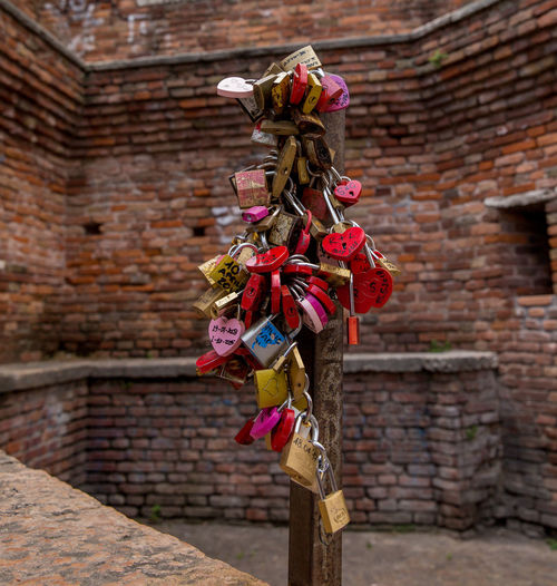 Close-up of decoration hanging against brick wall
