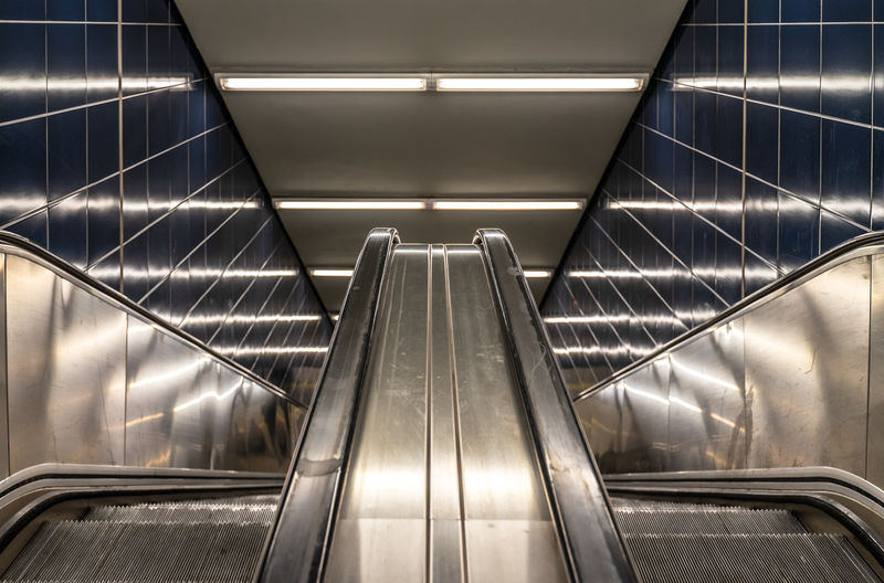 Escalator of illuminated subway station