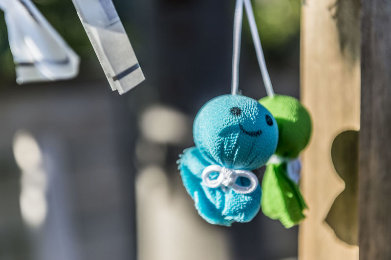 Close-up of toys hanging on clothesline
