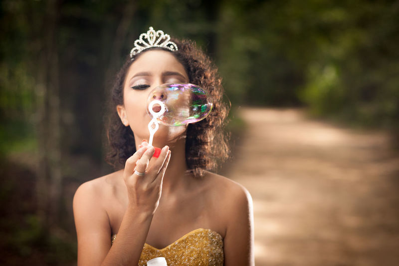 Teenage girl blowing bubble