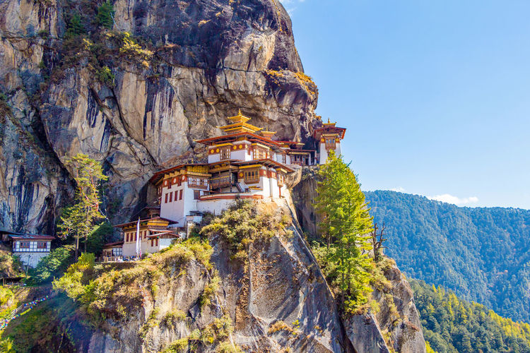 Buddhist temples on cliff against mountains