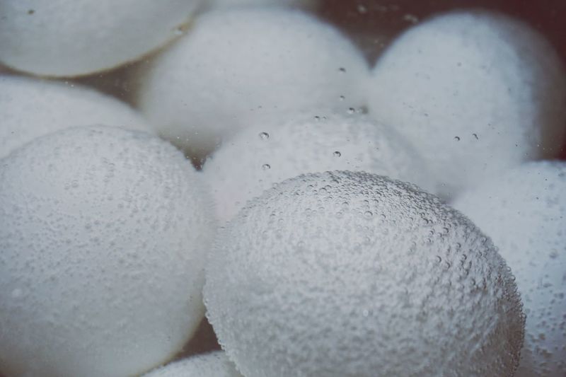Close-up of white eggs in boiling water
