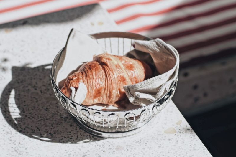 High angle view of croissant in bowl on marble
