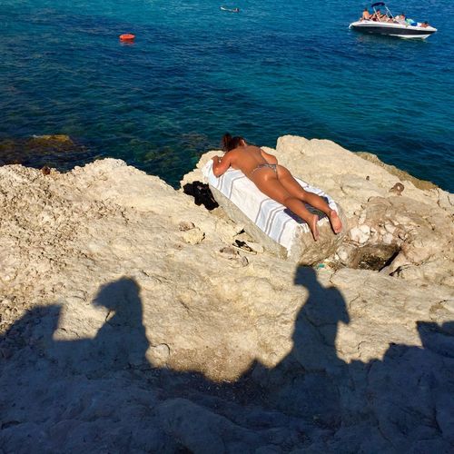 High angle view of man lying on shore
