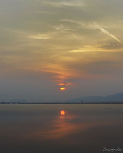 Scenic view of sea against romantic sky at sunset