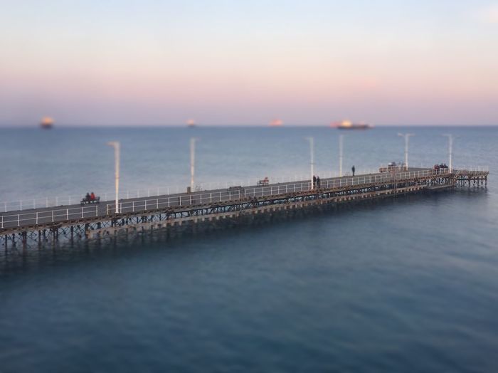 Pier on sea during sunset
