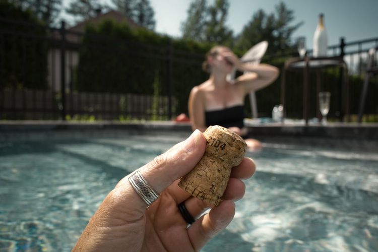 Midsection of man holding ice cream in swimming pool