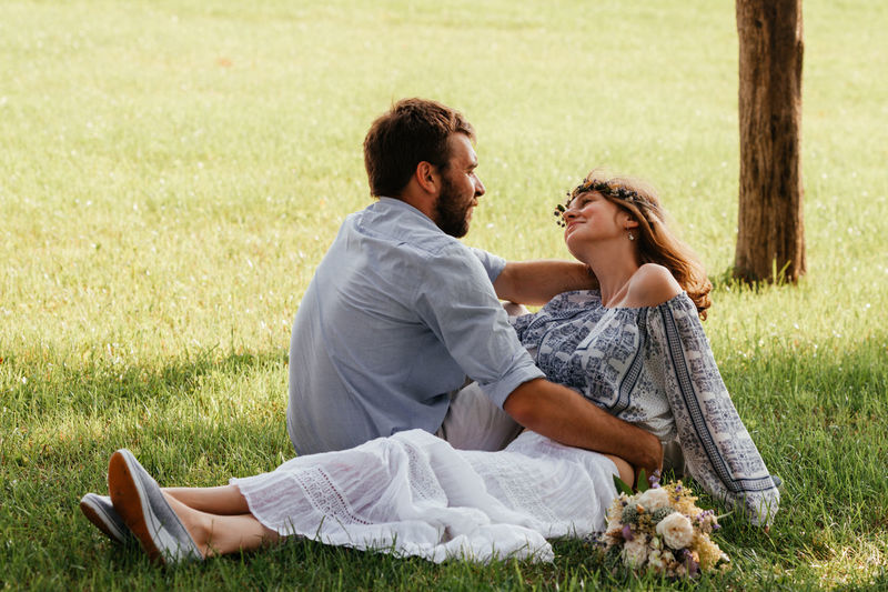 Young couple sitting on grass