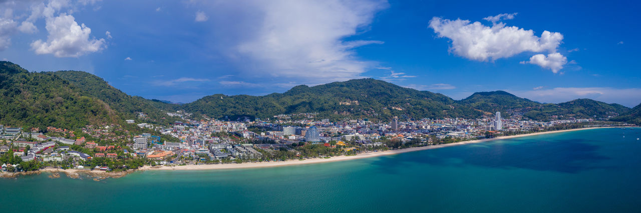 Panoramic view of sea and buildings against sky