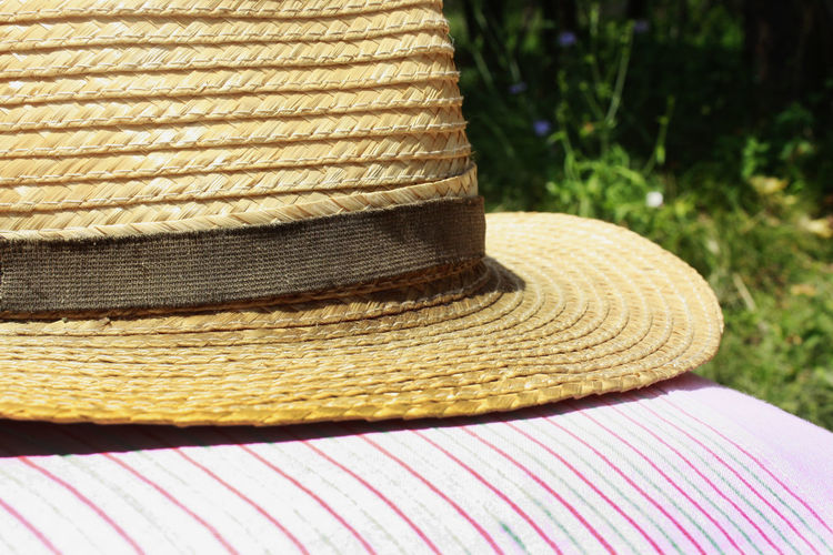 Close-up of straw hat on fabric