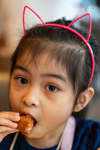 Cute girl eating food at restaurant