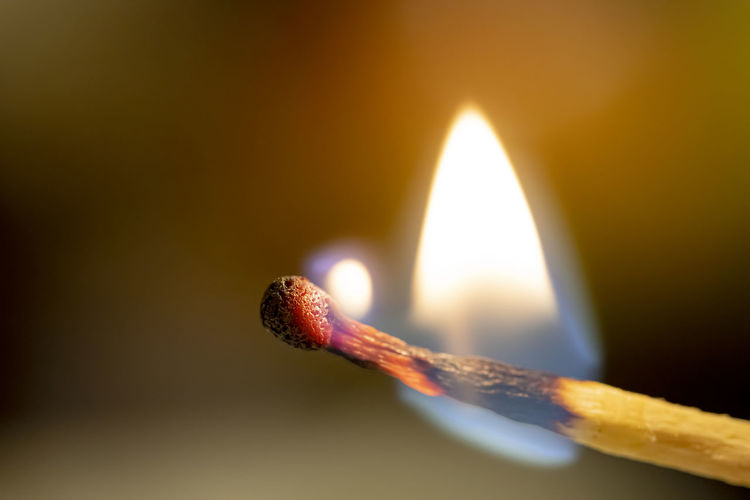 Close-up of burning matchstick