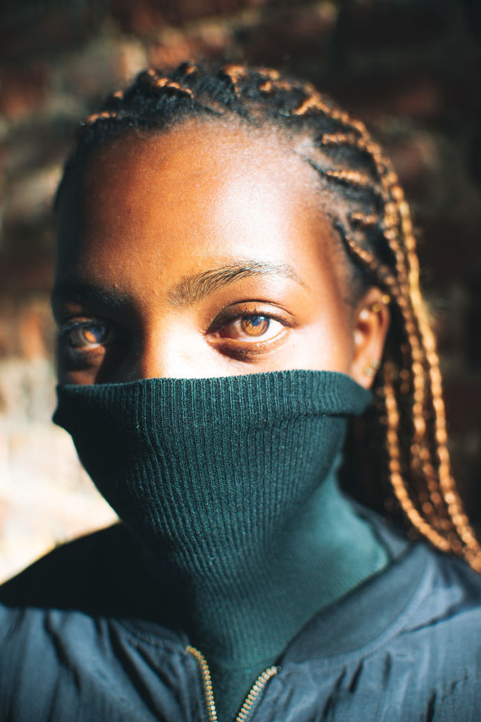 CLOSE-UP PORTRAIT OF YOUNG WOMAN COVERING FACE WITH EYES