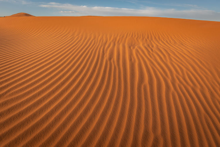 View of sand dune in desert against sky