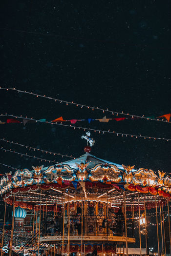 Festive children's merry go round carousel fun in the new year atmosphere with flying snow. 