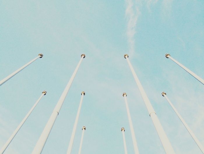 Low angle view of street light against blue sky