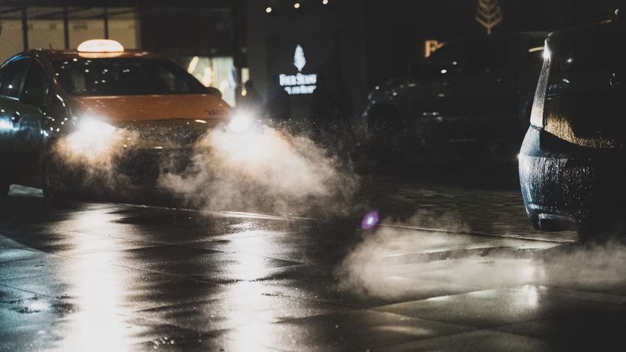 Wet table in illuminated city at night