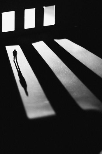 High angle view of silhouette man shadow on floor