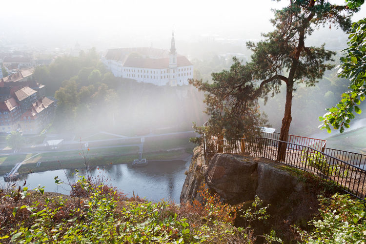 Bridge over river by buildings in city
