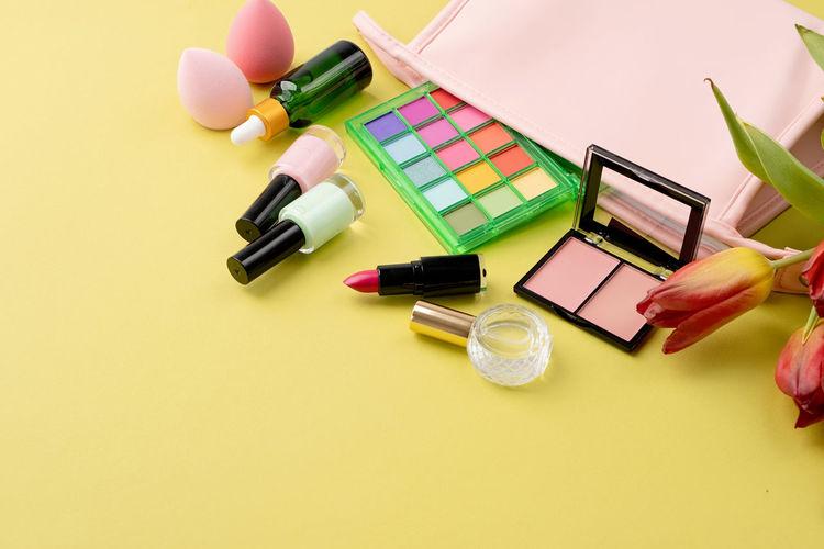 High angle view of beauty products on yellow background