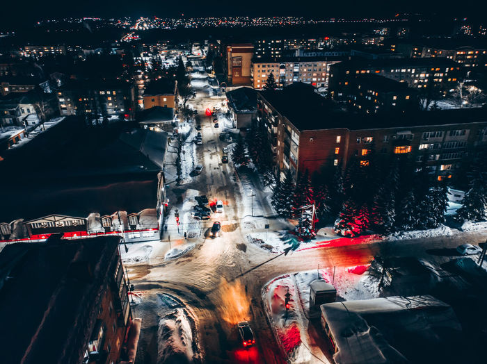 High angle view of city lit up at night