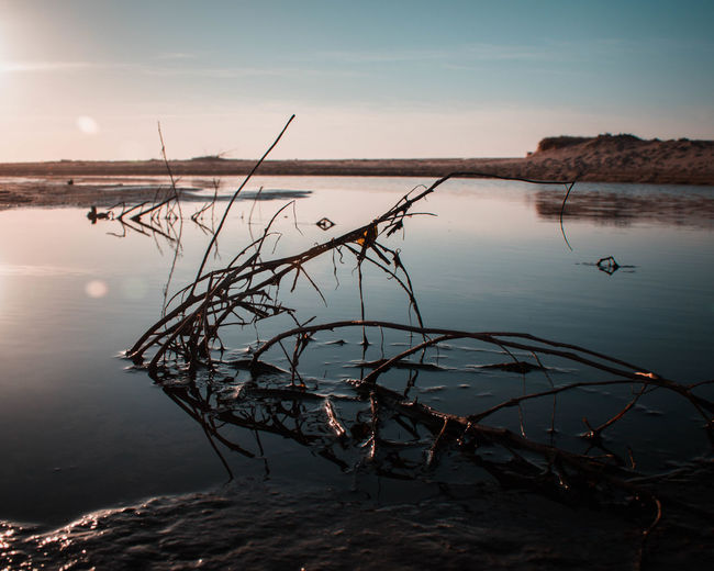 Scenic view of lake against sky during sunset
