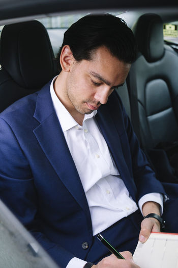 Portrait of businessman sitting in car